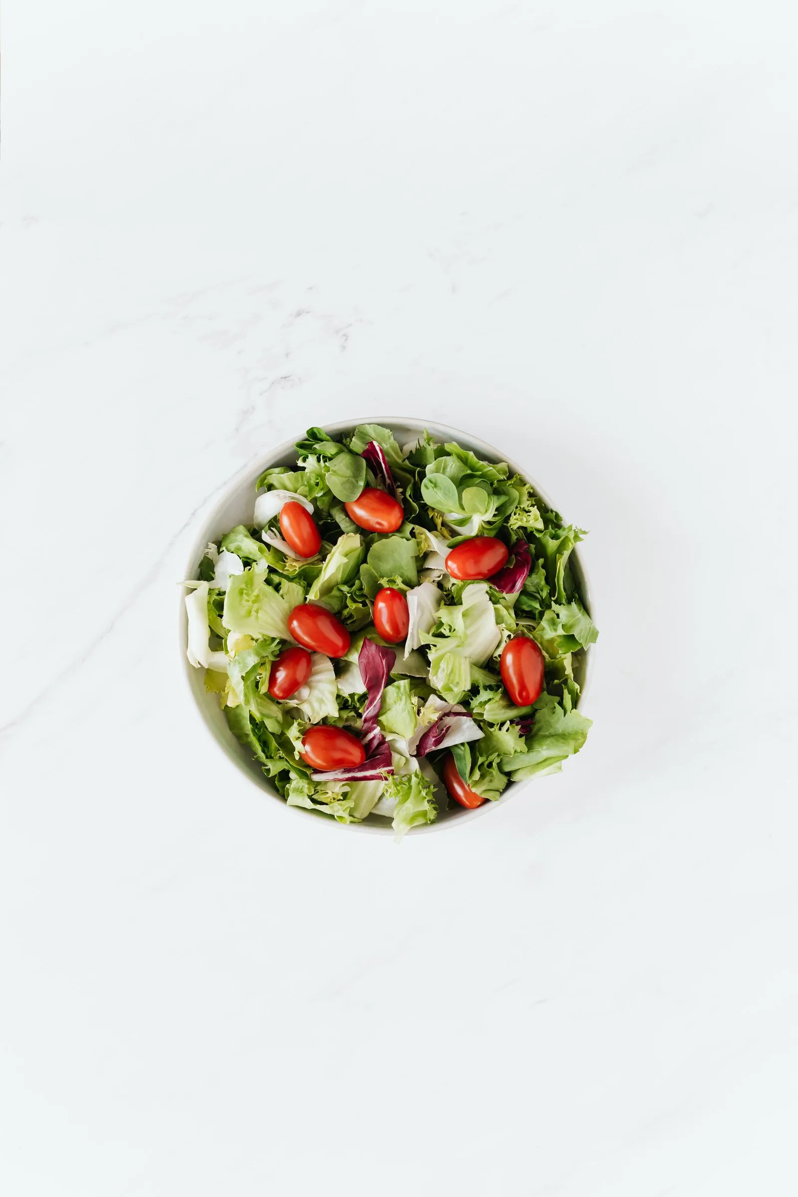 Representative fresh garden salad with tomatoes and crisp greens.