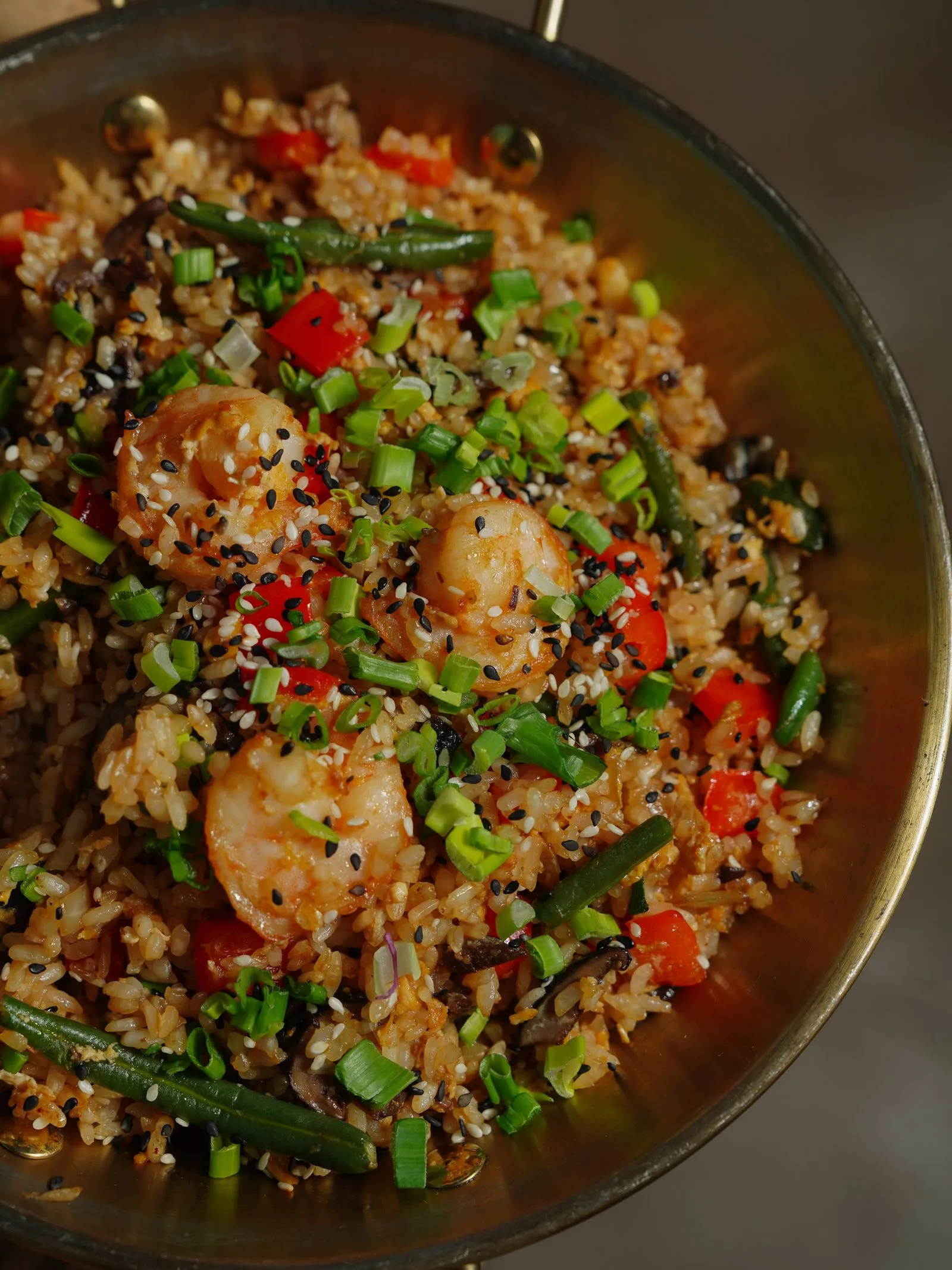 Representative shrimp fried rice with vegetables and scallions.